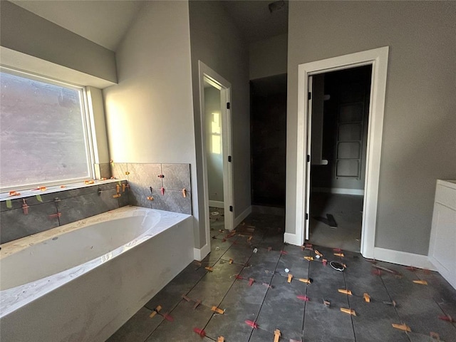 bathroom featuring a tub to relax in