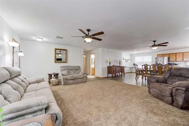 carpeted living room featuring ceiling fan