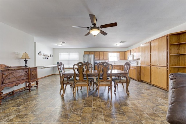 dining area with sink and ceiling fan