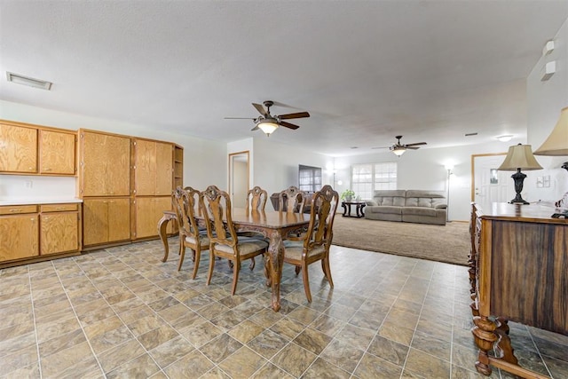 carpeted dining space featuring ceiling fan