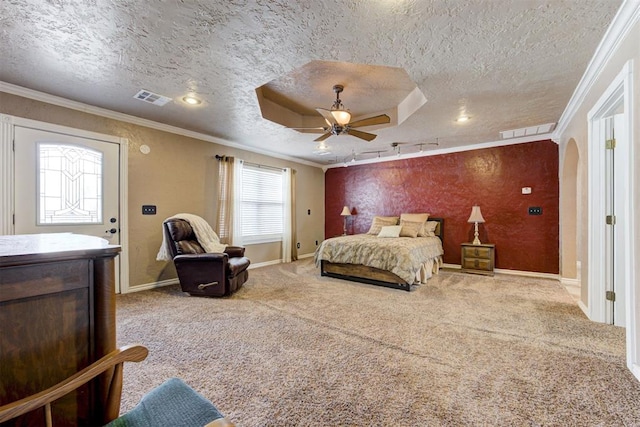 bedroom featuring ornamental molding, carpet flooring, ceiling fan, and a textured ceiling