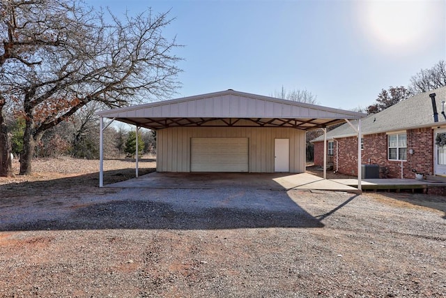 garage featuring a carport and central AC