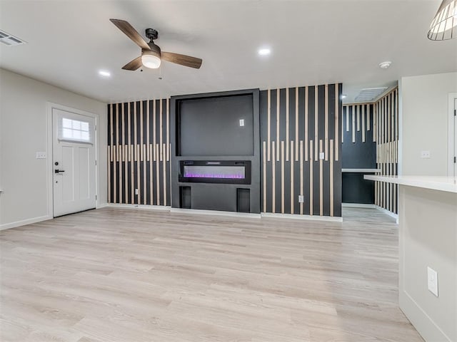 unfurnished living room featuring light hardwood / wood-style floors and ceiling fan