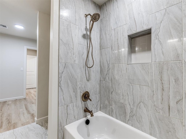 bathroom featuring tiled shower / bath