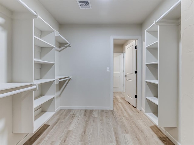 spacious closet with light hardwood / wood-style flooring