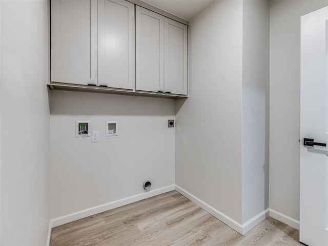 clothes washing area with cabinets, washer hookup, light hardwood / wood-style flooring, and electric dryer hookup