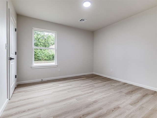 spare room featuring light wood-type flooring