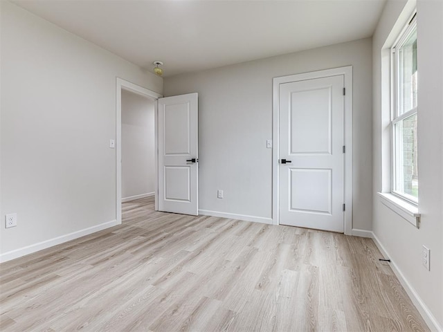 unfurnished bedroom with light wood-type flooring