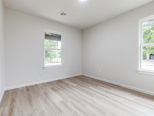 unfurnished room with light hardwood / wood-style floors