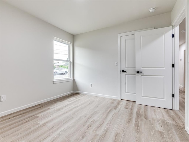 unfurnished bedroom featuring light wood-type flooring