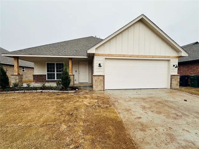 view of front of home with a garage, brick siding, a shingled roof, driveway, and board and batten siding