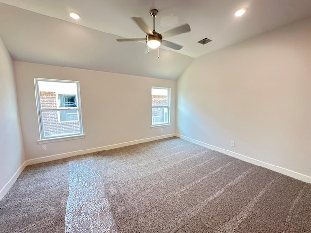 carpeted spare room with vaulted ceiling and ceiling fan