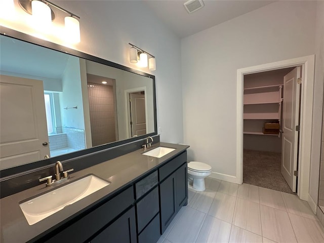 bathroom with a shower, vanity, and toilet