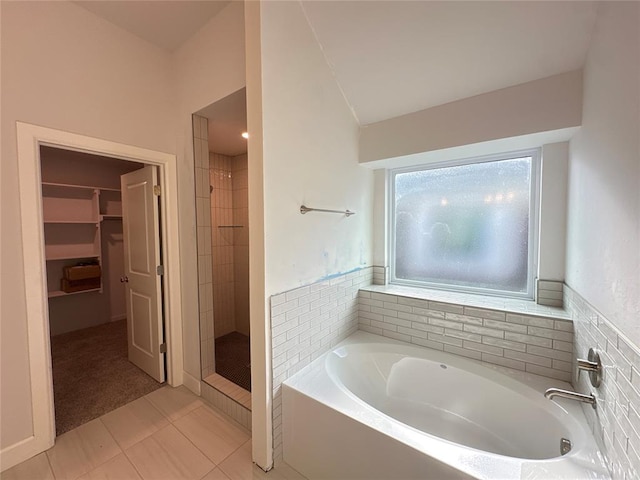 bathroom with tile patterned flooring and plus walk in shower