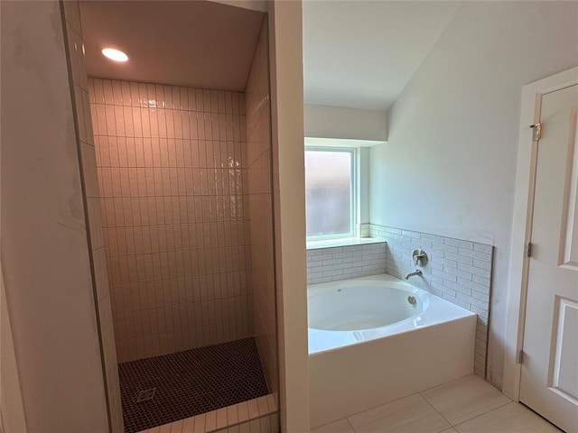 bathroom featuring tile patterned floors and independent shower and bath