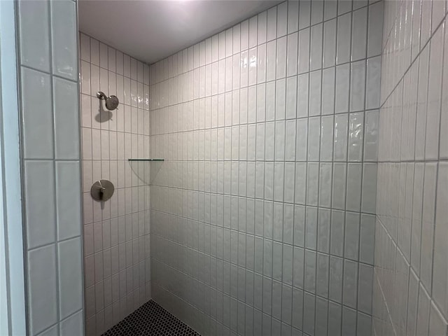 bathroom with tiled shower