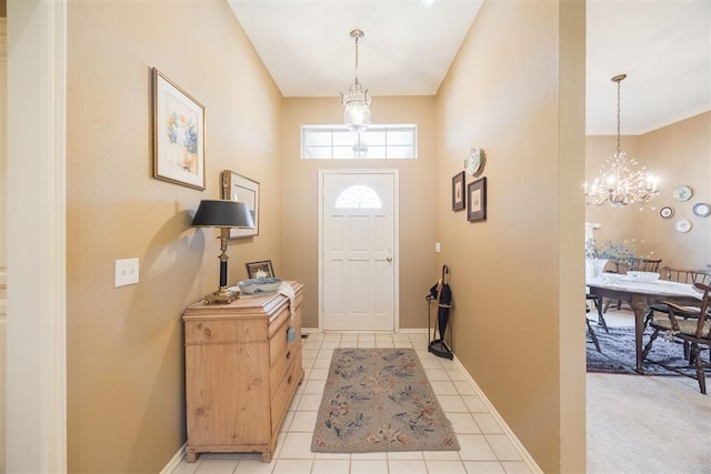 tiled entrance foyer with a chandelier