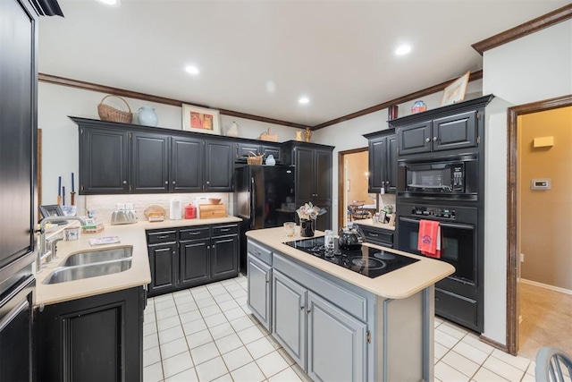 kitchen featuring a center island, sink, light tile patterned floors, black appliances, and ornamental molding