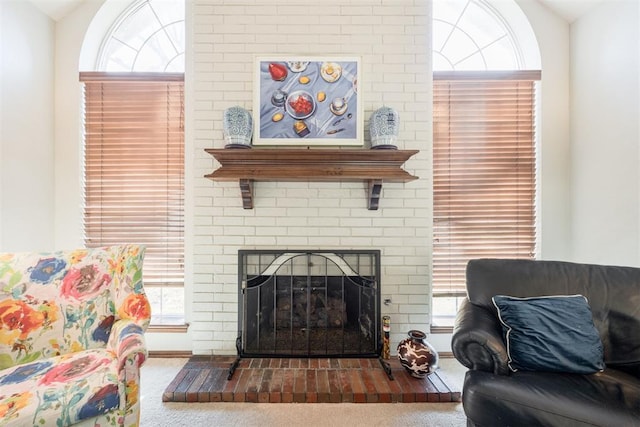 living room with a fireplace, carpet floors, a wealth of natural light, and lofted ceiling