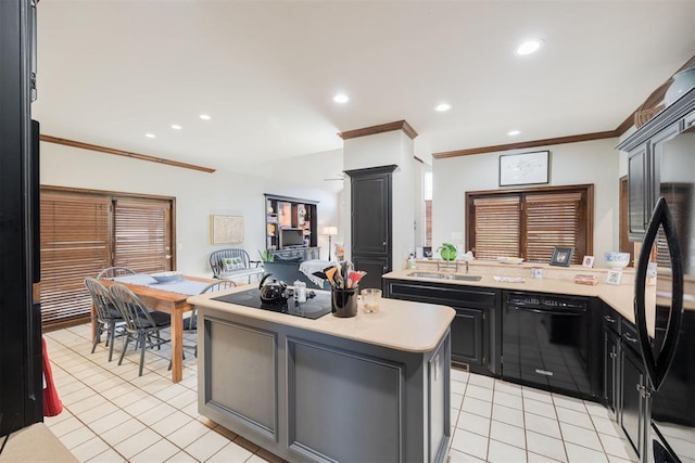 kitchen with light tile patterned floors, a kitchen island, crown molding, and black appliances