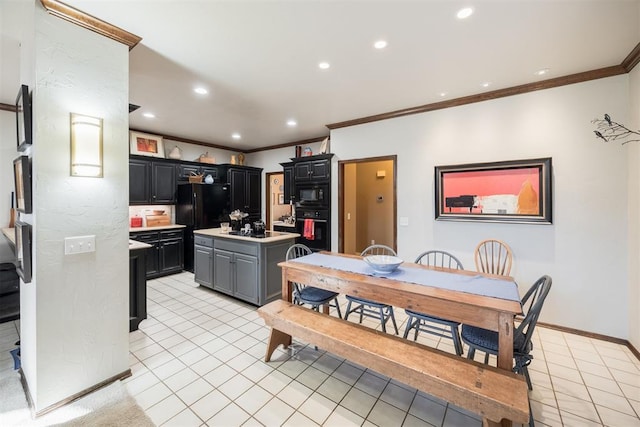 kitchen featuring black appliances, crown molding, gray cabinets, a kitchen island, and light tile patterned flooring