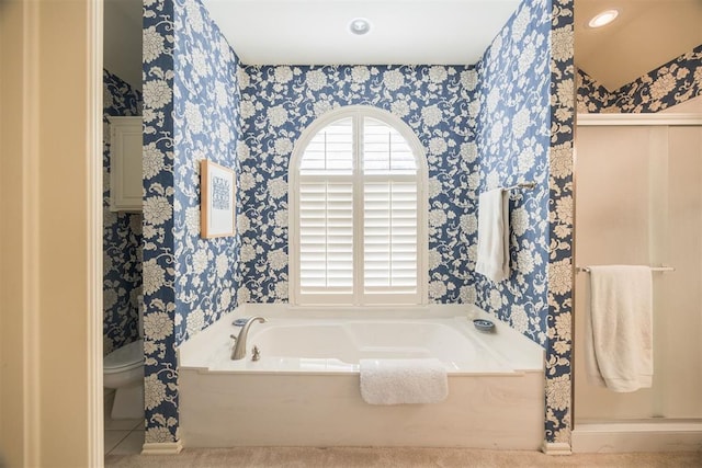 bathroom featuring toilet and a tub