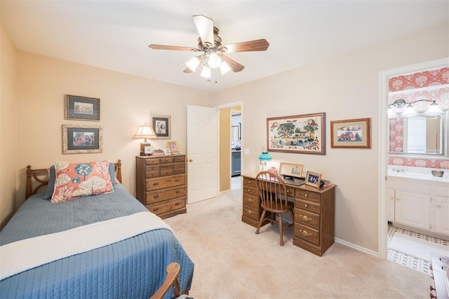 carpeted bedroom with ensuite bath and ceiling fan