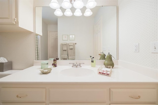 bathroom with vanity and a notable chandelier