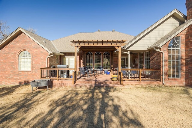 rear view of house featuring a pergola and a patio