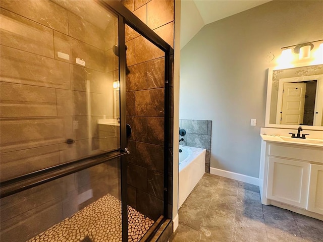 bathroom featuring plus walk in shower, vaulted ceiling, and vanity