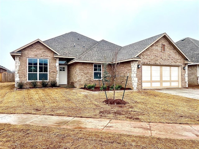 view of front of house featuring a garage and a front lawn