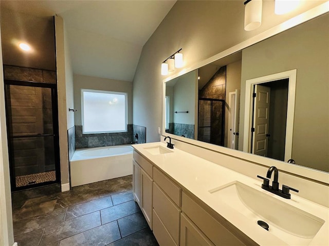 full bath with vaulted ceiling, a bath, a shower stall, and a sink