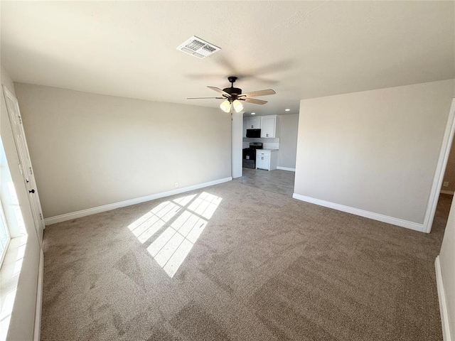 unfurnished living room featuring carpet flooring and ceiling fan