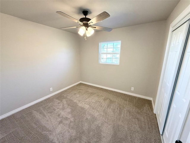 spare room with carpet floors and ceiling fan