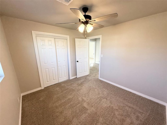 unfurnished bedroom featuring carpet, a closet, and ceiling fan