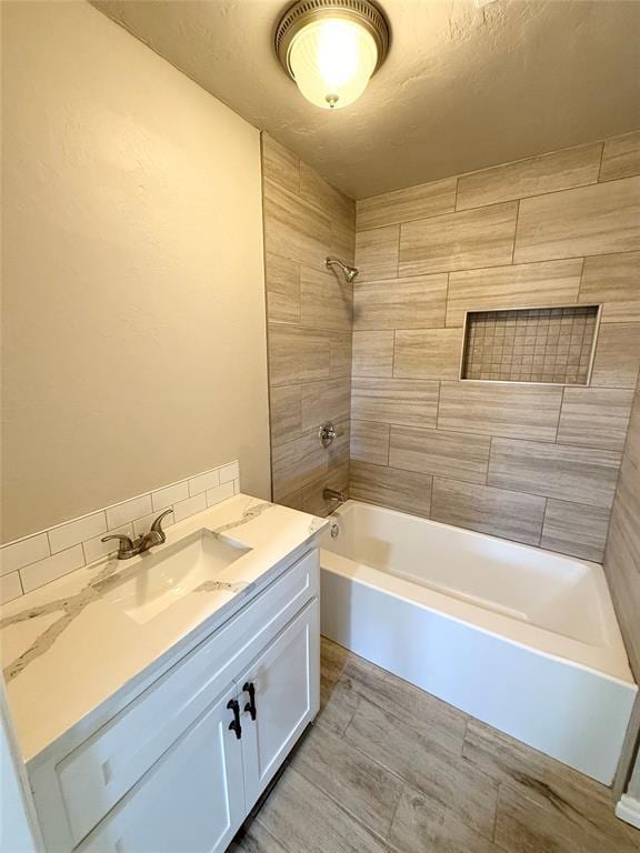 bathroom with vanity and tiled shower / bath combo