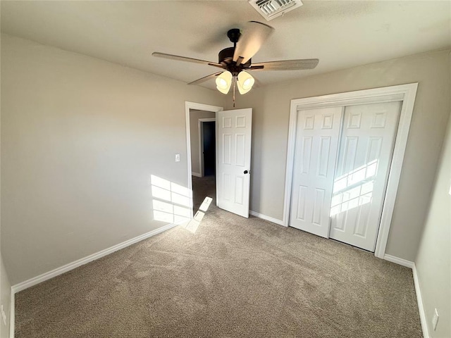 unfurnished bedroom with carpet flooring, a closet, and ceiling fan