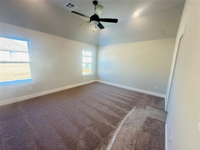 carpeted spare room with ceiling fan and vaulted ceiling