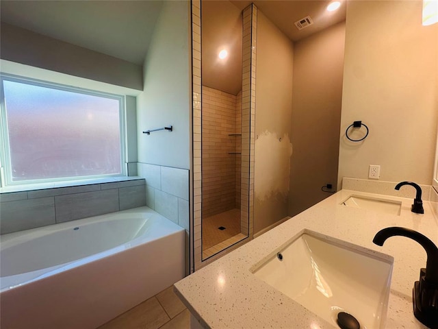 bathroom with shower with separate bathtub, tile patterned floors, and vanity