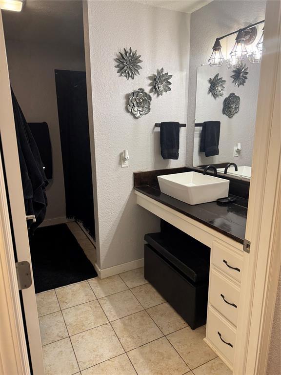 bathroom with tile patterned flooring and vanity