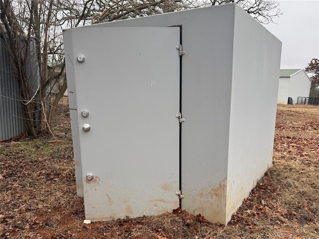 view of storm shelter featuring a storage shed