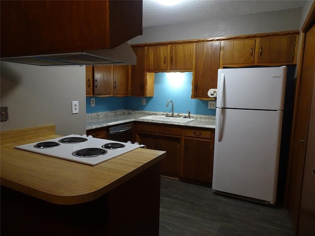 kitchen featuring dark wood-type flooring, white appliances, kitchen peninsula, and sink