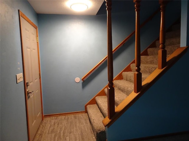 stairs with hardwood / wood-style floors