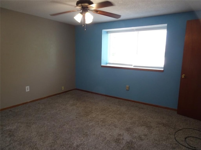 empty room with ceiling fan and carpet