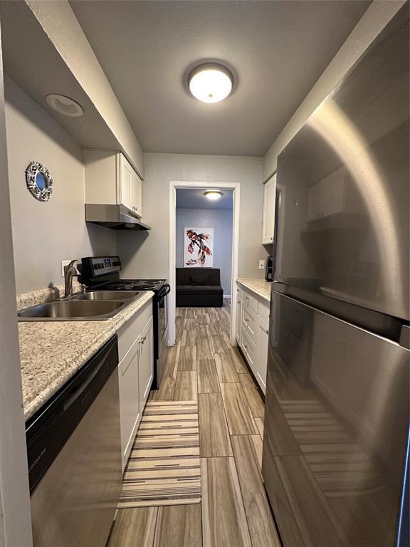 kitchen featuring sink, white cabinets, and appliances with stainless steel finishes