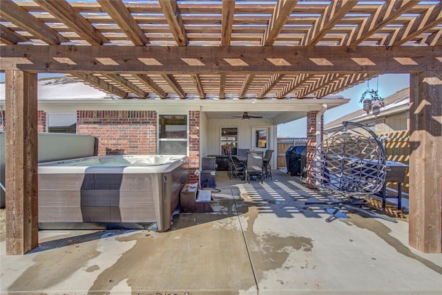 view of patio with grilling area, ceiling fan, a hot tub, and a pergola