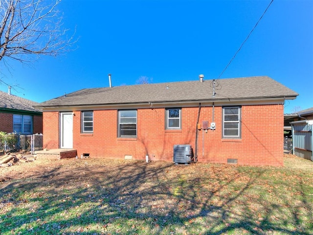 back of house with a lawn and cooling unit