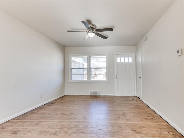 foyer entrance with ceiling fan and light hardwood / wood-style flooring