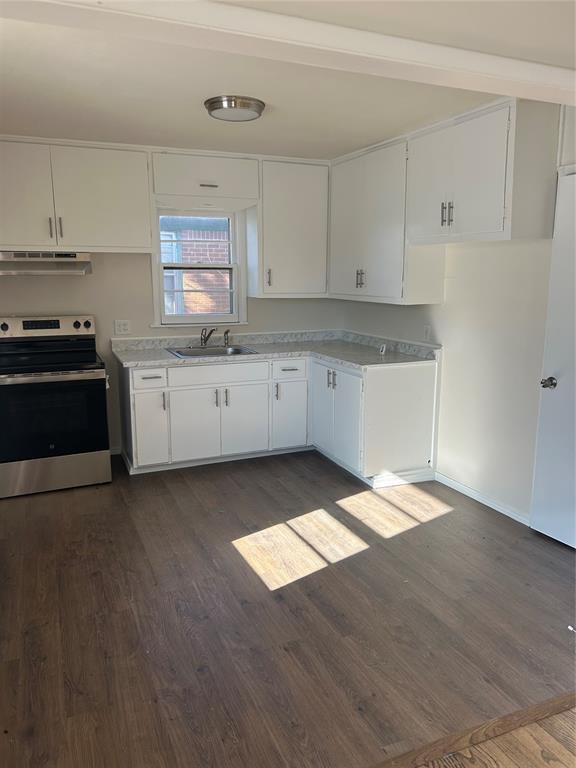 kitchen featuring white cabinets, ventilation hood, dark hardwood / wood-style floors, and stainless steel range with electric cooktop