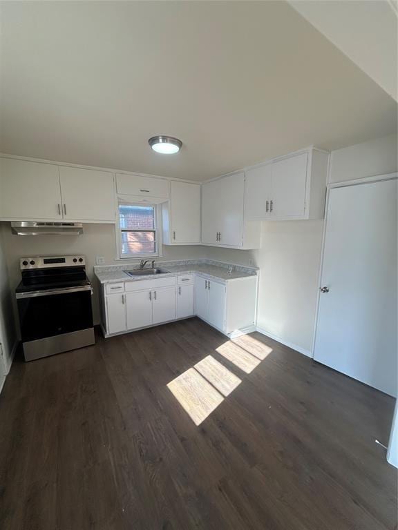 kitchen featuring white cabinets, sink, electric stove, and dark wood-type flooring